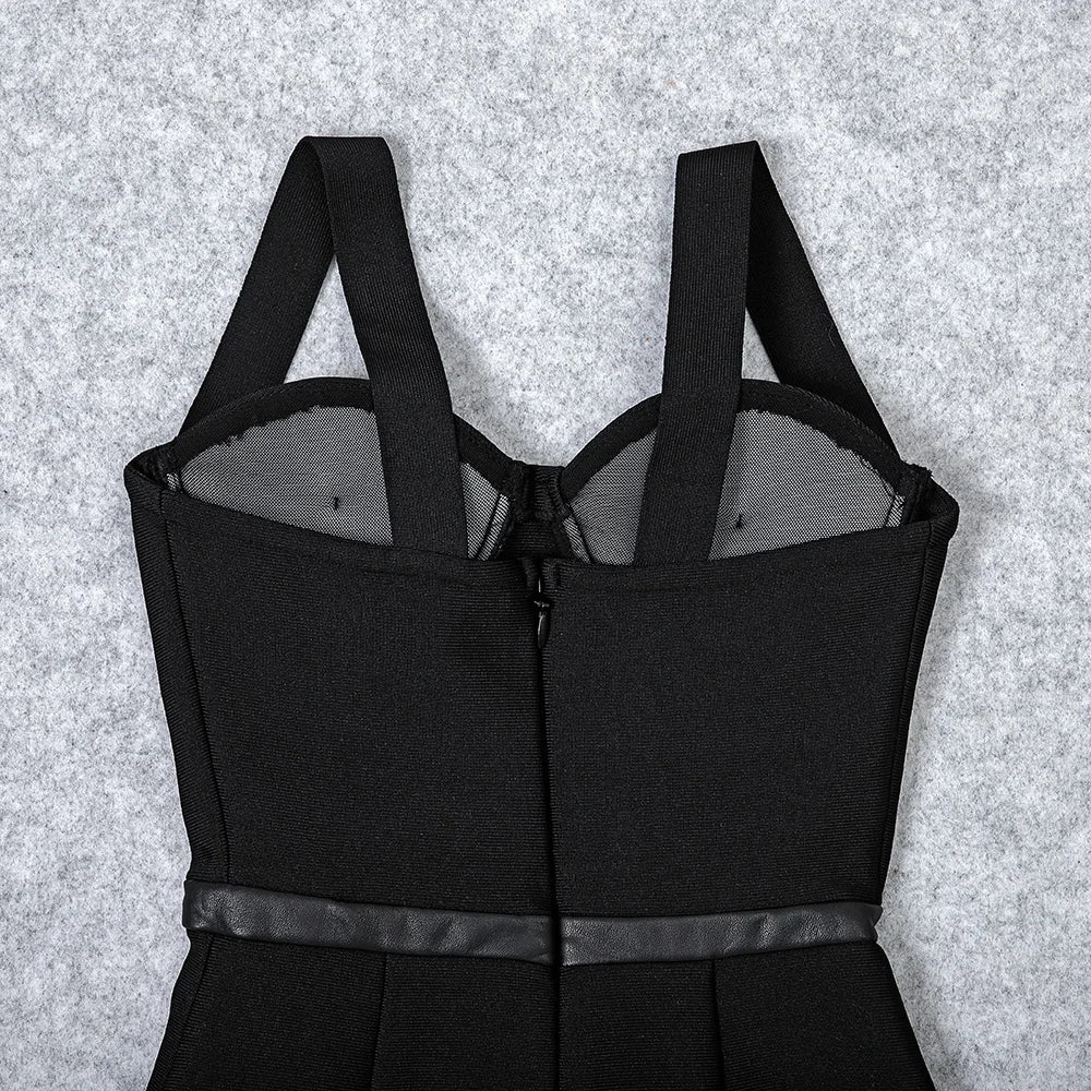 Black dress with thin straps on a textured gray background