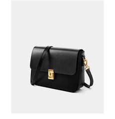 Black handbag with a gold clasp on a white background