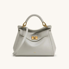 Light grey smooth leather top handle bag with gold hardware.