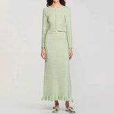 Light green knit cardigan and midi skirt set worn by a model.