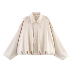 Beige cape-style jacket on a white background