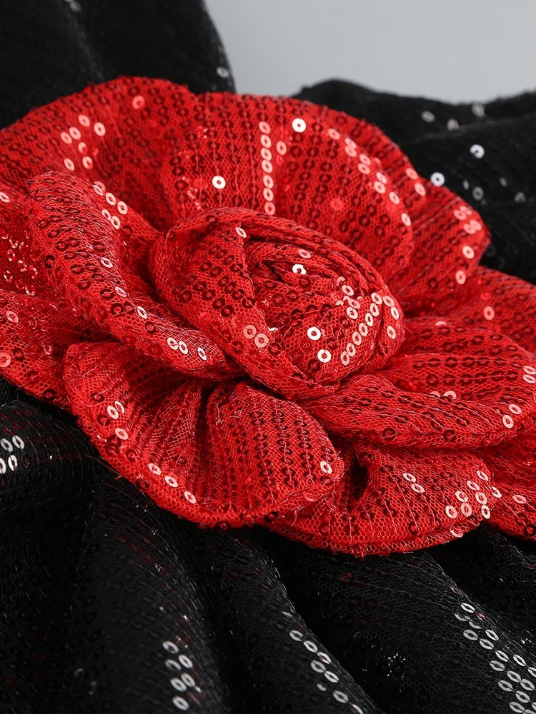 Red sequin flower on a black background