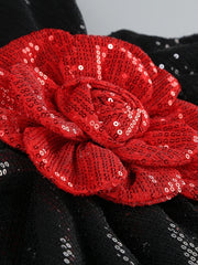 Red sequin flower on a black background