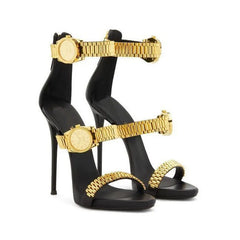 Gold metal watch strap dress heels on a white background