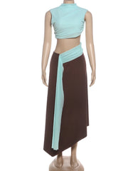 Mannequin wearing a brown and a light blue dress with a ribbon.