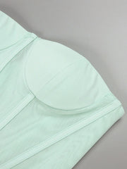Light green bra on a gray background