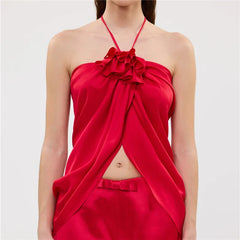 Close-up of the ruffled flower detail on a red halter crop top.
