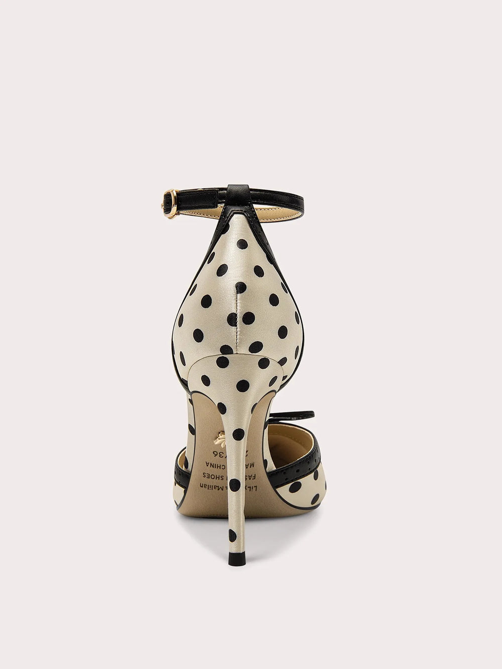 Polka dot high-heeled shoes on a white background