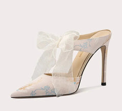 High-heeled shoe with a bow on a white background