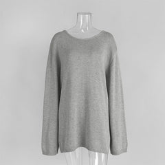 Gray sweater on a mannequin against a plain background