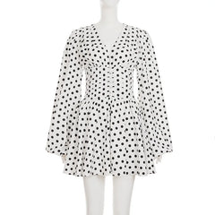 White dress with black polka dots on a mannequin against a white background