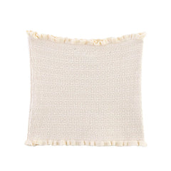 Textured cream pillow with tassel trim on a white background
