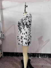 Black and white fur coat on a mannequin against a plain background