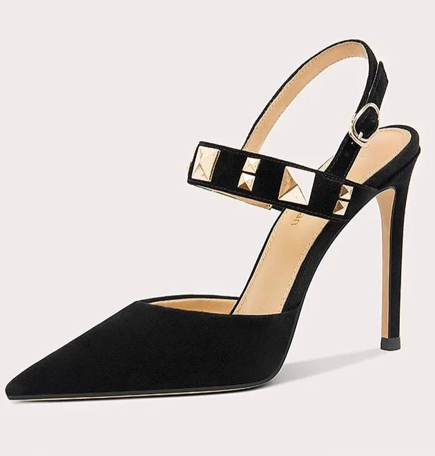 Black high-heeled shoe with studded detail on a light gray background