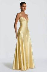 Side view of yellow satin spaghetti strap deep V-neck maxi dress