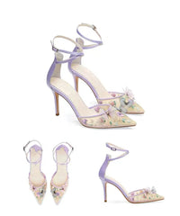 Pair of high-heeled shoes with floral design on a white background
