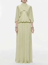 Green chiffon maxi dress with cape sleeves and jewel buckle