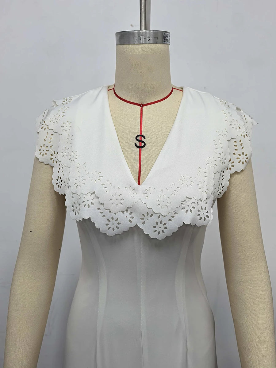 White lace-trimmed top on a mannequin with a plain background