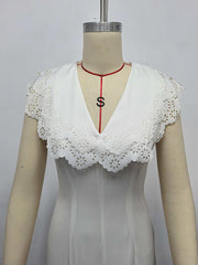 White lace-trimmed top on a mannequin with a plain background