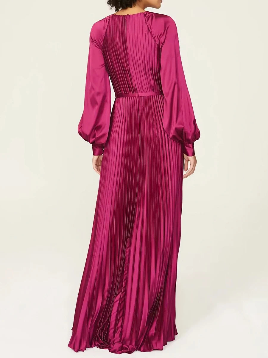 Fuchsia pleated dress with long sleeves on a white background