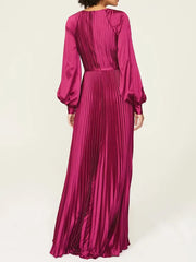 Fuchsia pleated dress with long sleeves on a white background