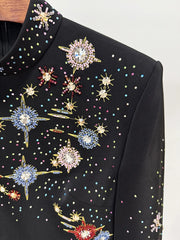 Black garment with colorful star-shaped embellishments on a white background