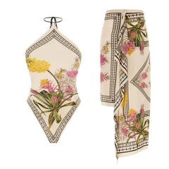 One-piece swimsuit with botanical print and a sarong skirt.