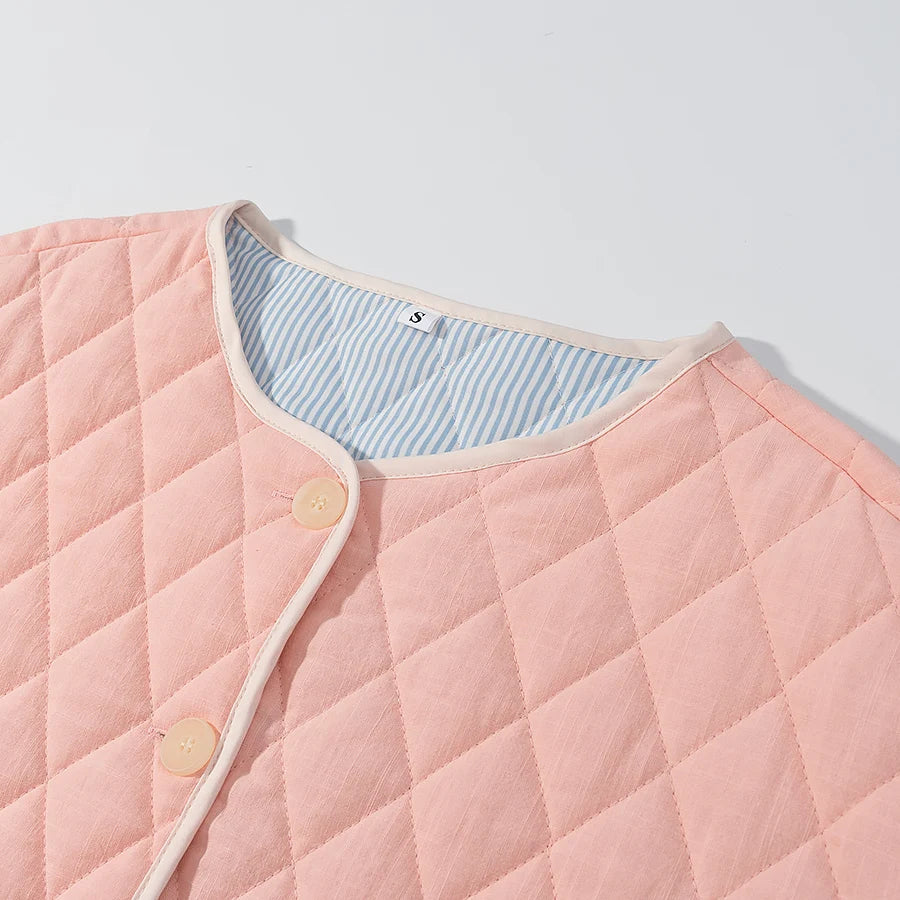 Pink quilted jacket with button details on a light gray background