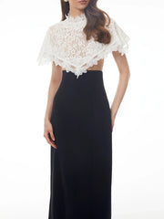 Sheath dress with a white lace cape overlay, front view.