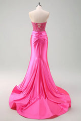 Pink evening gown on a mannequin against a gray background