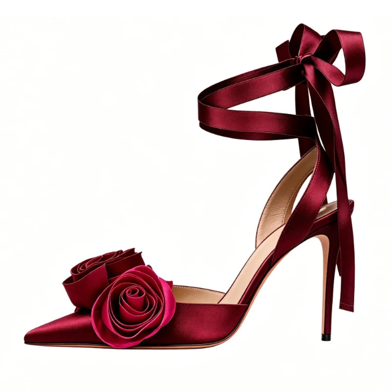 Burgundy satin stiletto sandals with rose embellishments and ankle tie.