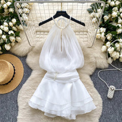 White dress on a hanger with decorative elements on a textured surface