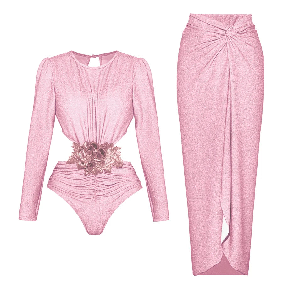 Long-sleeved pink cut-out bodysuit with floral applique and matching ruched wrap maxi skirt.