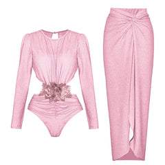 Long-sleeved pink cut-out bodysuit with floral applique and matching ruched wrap maxi skirt.