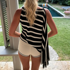 Back view of a striped asymmetrical knit top worn by a model.
