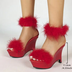 Close-up of red feather trim wedge platform sandals with heel height measurement