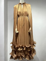 Brown dress with long sleeves and ruffled skirt on a mannequin against a gray background
