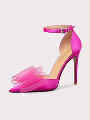 Pink high-heeled shoe with tulle details on a light gray background