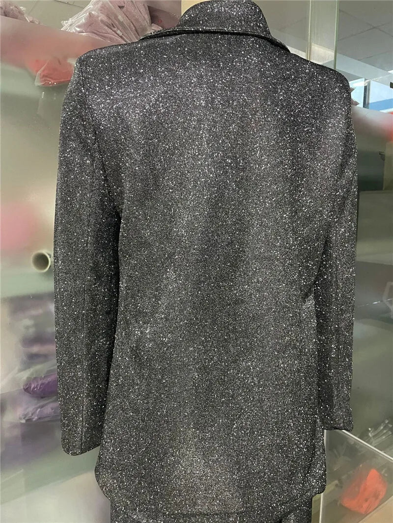 Silver glittery jacket on a mannequin against a blurred indoor background