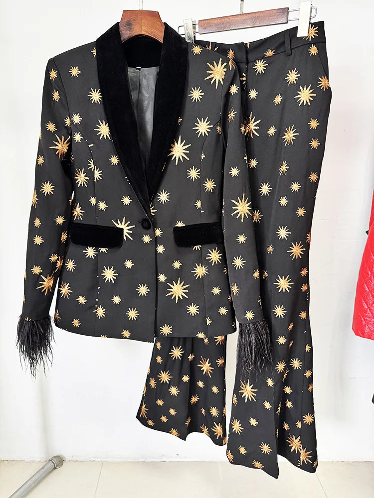 Black star embroidered blazer and flare pants set hanging on a rack.