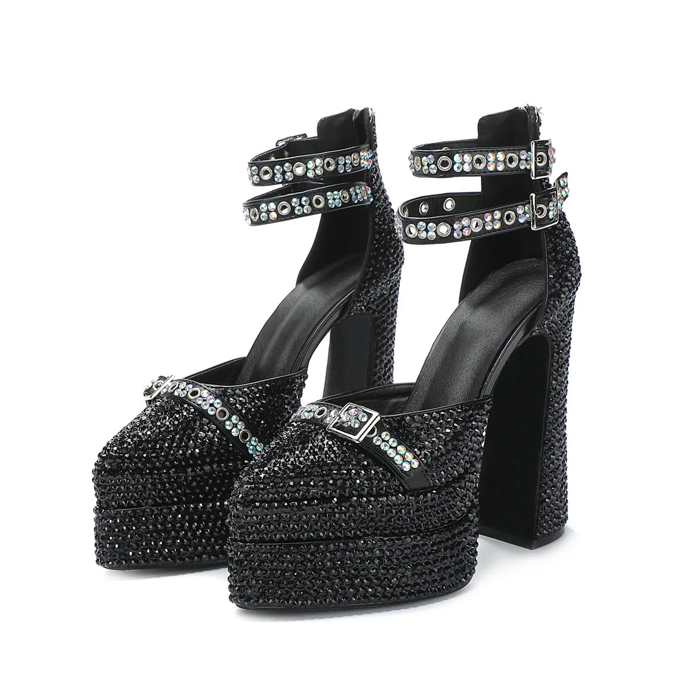 Black high-heeled shoes with crystal embellishments on a white background