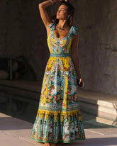 Woman wearing a vibrant print one-piece swimsuit with bow shoulder detail