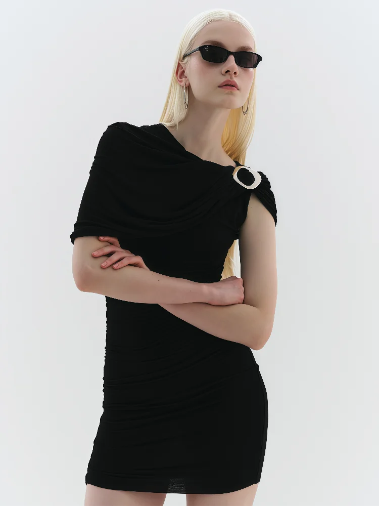 Woman wearing a black dress with a unique design on a white background