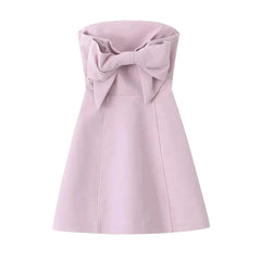 Pink dress with a large bow on a white background