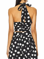 Sleeveless halter crop top with matching polka dot A-line skirt.