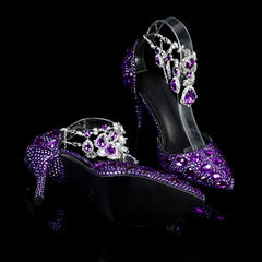 Purple high-heeled shoes with crystal embellishments on a black background