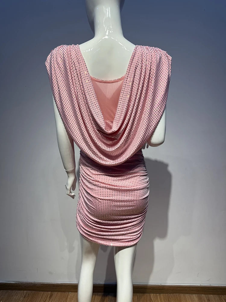 Mannequin wearing a pink dress with a draped back design against a plain background