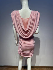 Mannequin wearing a pink dress with a draped back design against a plain background
