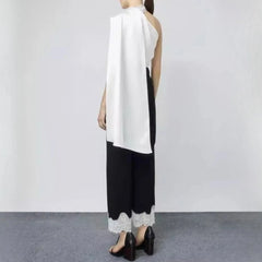 Mannequin wearing a white top and black pants with lace trim