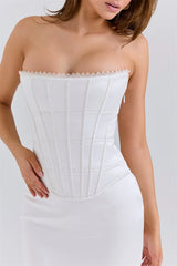 White strapless dress with lace neckline on a plain background